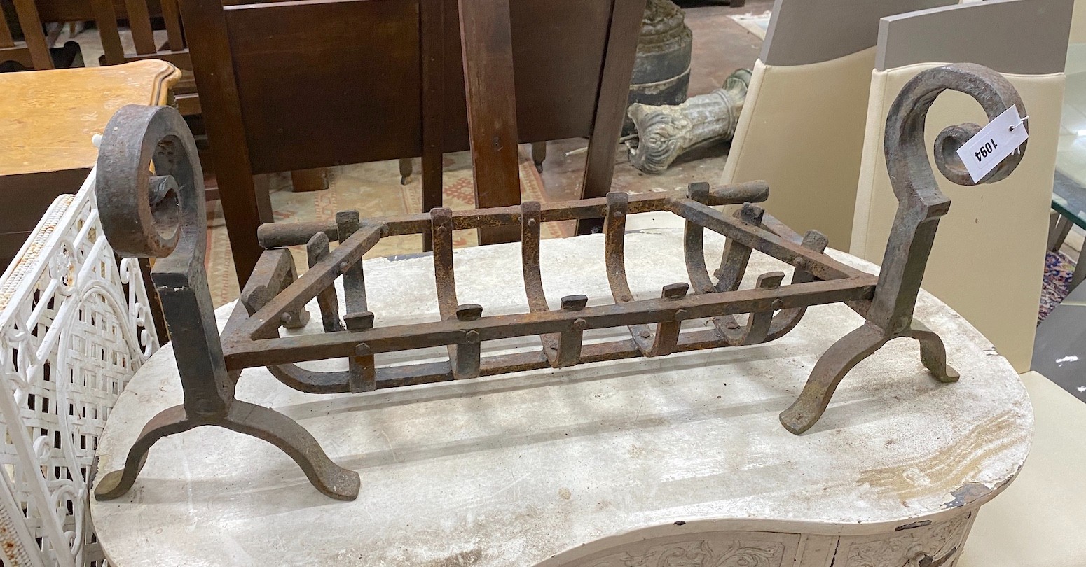 A wrought iron fire basket, width 97cm, depth 31cm, height 41cm and fire-dogs